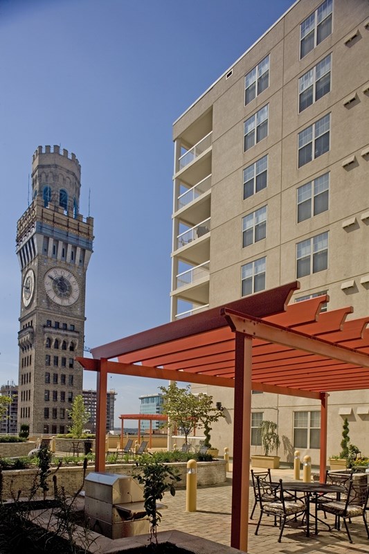 a large clock tower with a building in the background
