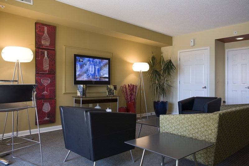 a living room with a tv and a table and chairs