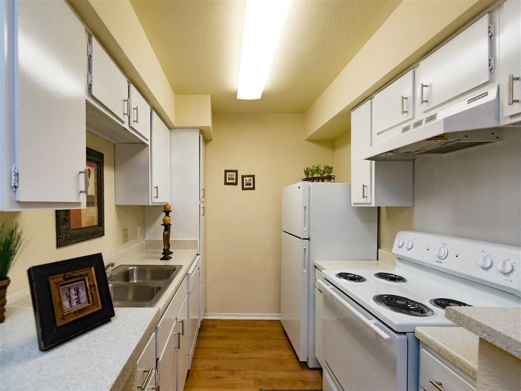 a kitchen with white appliances and white cabinets