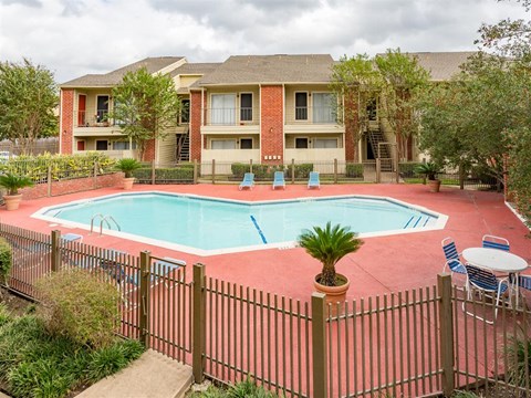 a swimming pool in front of an apartment building