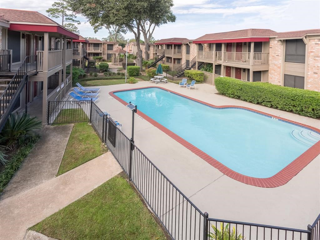 a resort style pool with a fence around it