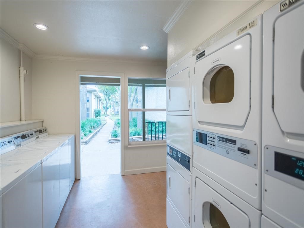 a washer and dryer in a laundry room with a window
