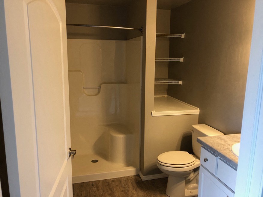 a small bathroom with a toilet and a shower