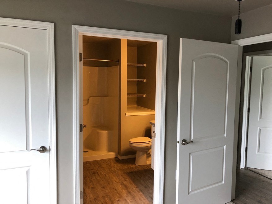 a small bathroom with a toilet and a closet