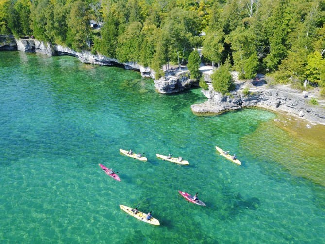 a group of kayaks on the water in a river