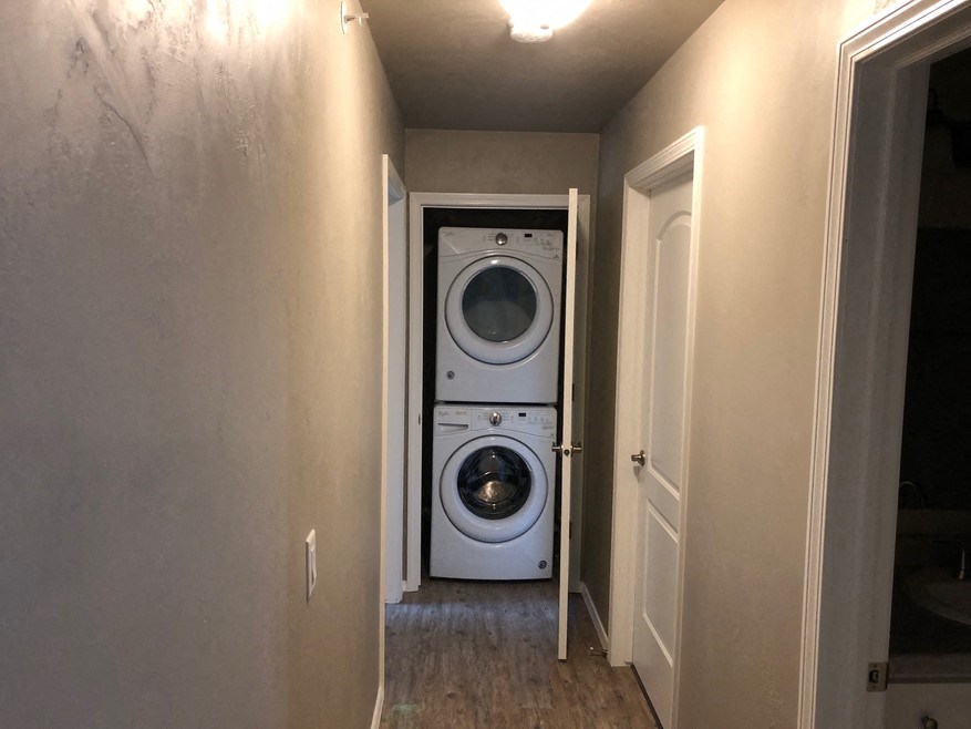 a washer and dryer in a small room in a hallway