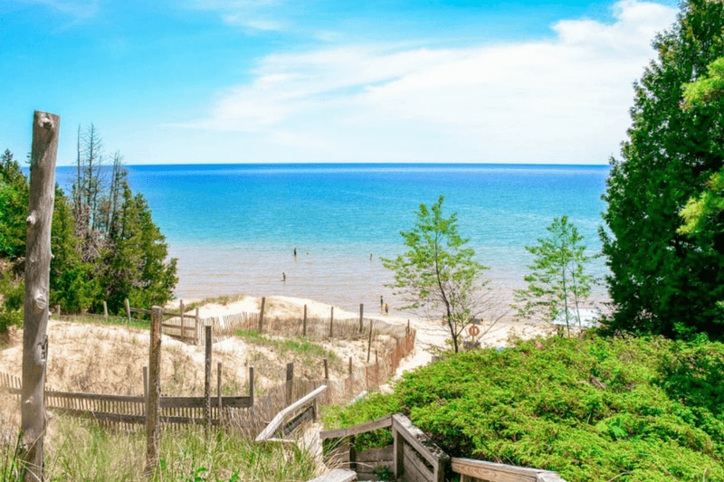 a view of a beach and the ocean from a cliff