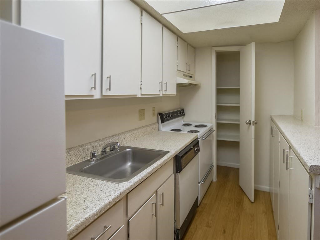 a kitchen with white cabinets and a sink