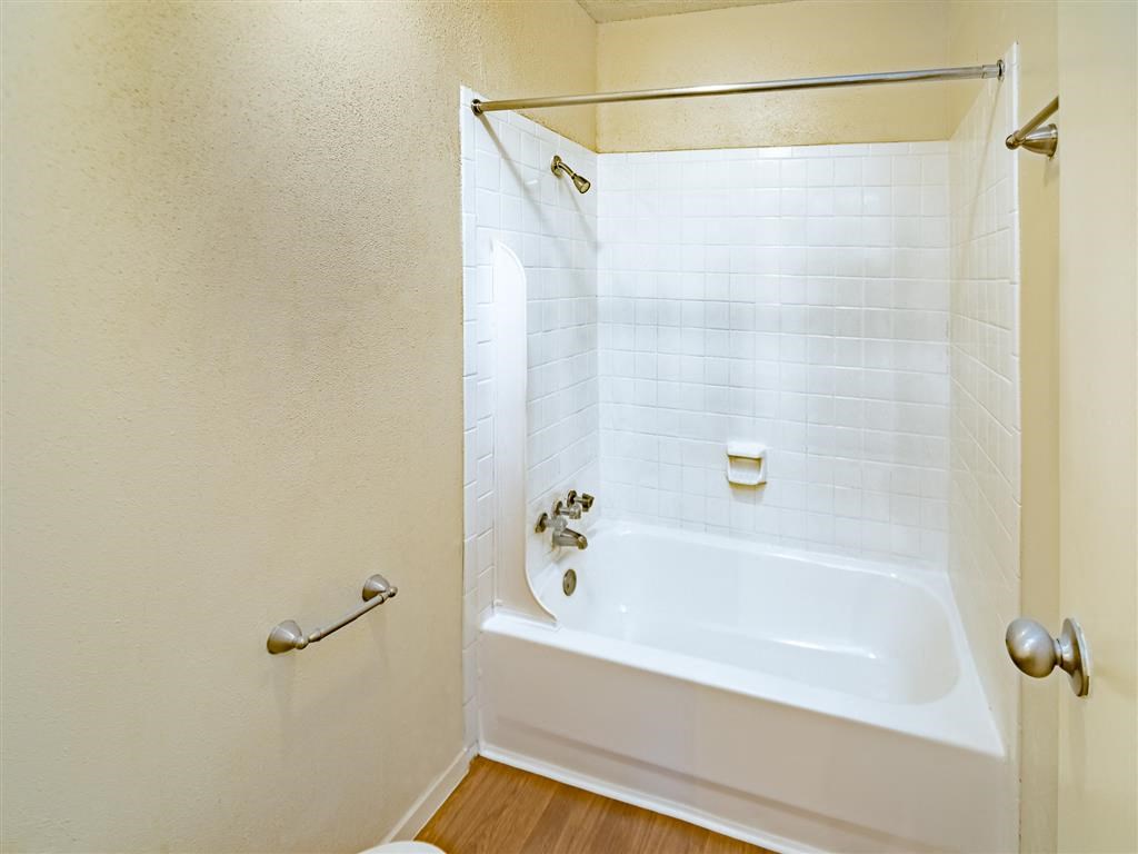 a bathroom with a tub and a shower
