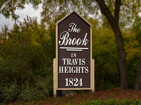 a sign that says the brook in travis heights