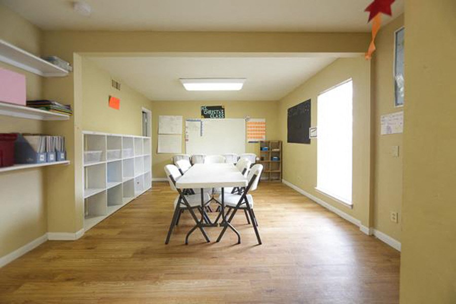 a dining room with a white table and chairs