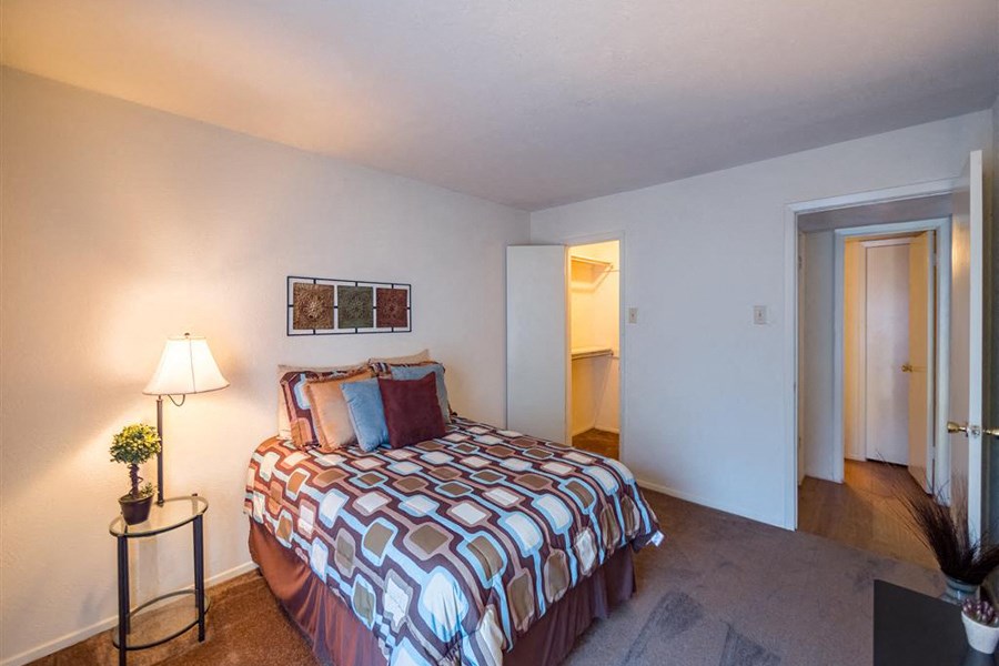 a bedroom with a bed and a door to a bathroom