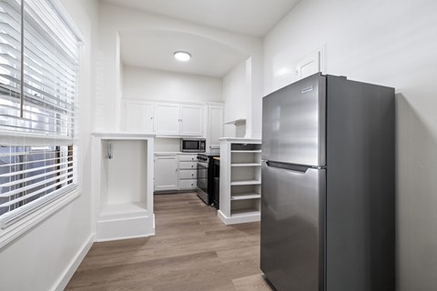 A modern kitchen with a refrigerator on the right.
