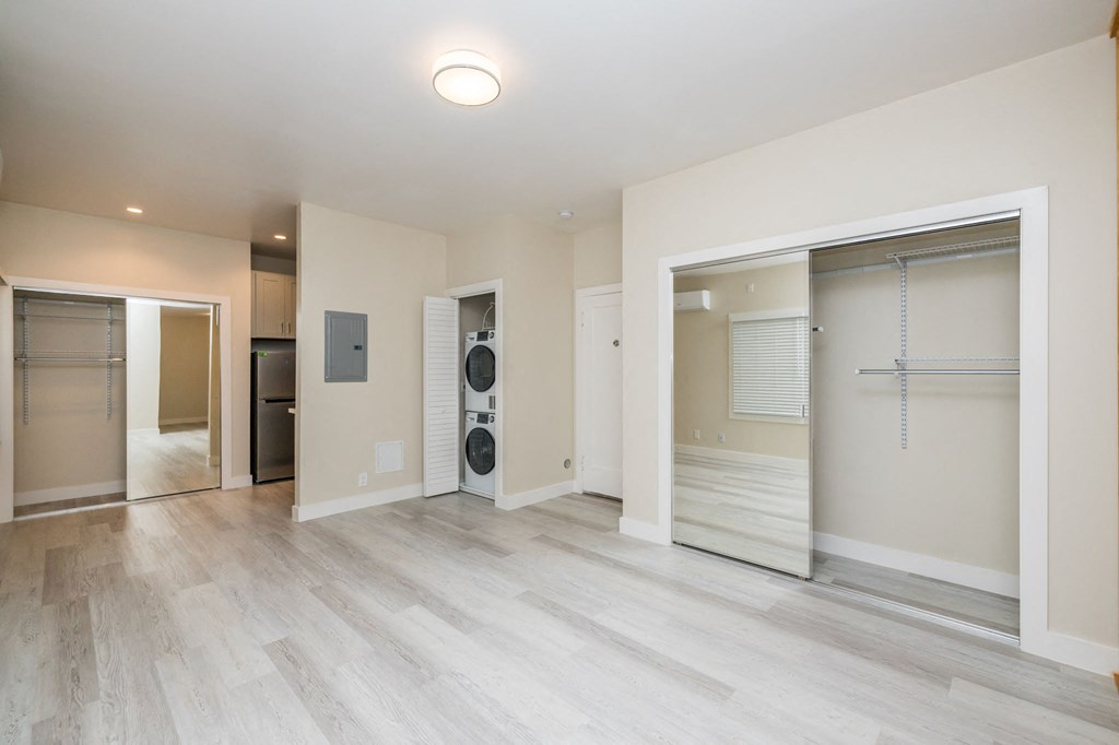 a renovated living room with a washer and dryer closet and a laundry room