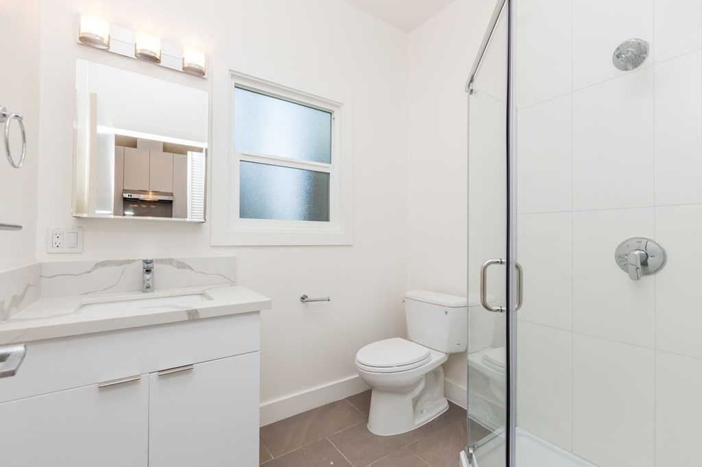 a bathroom with a sink toilet and a shower