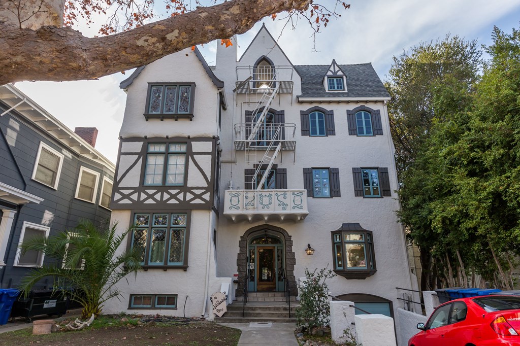 a white house with a tree in front of it