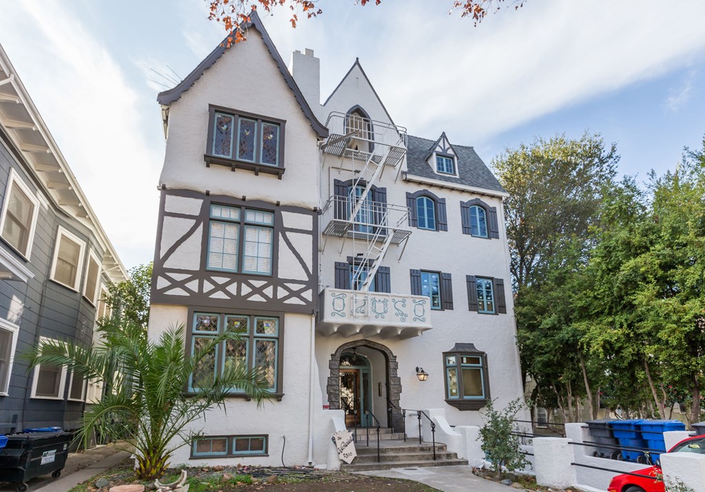 the facade of a house with a turret and a balcony