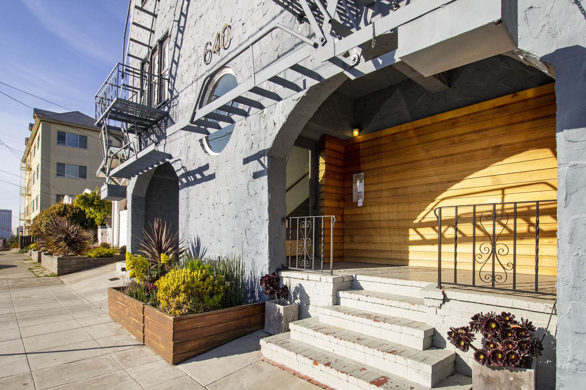 A building with a fire escape and a wooden door.