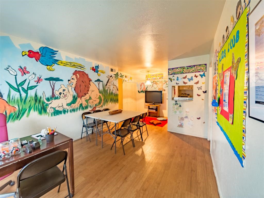 a dining room with a table and a mural on the wall