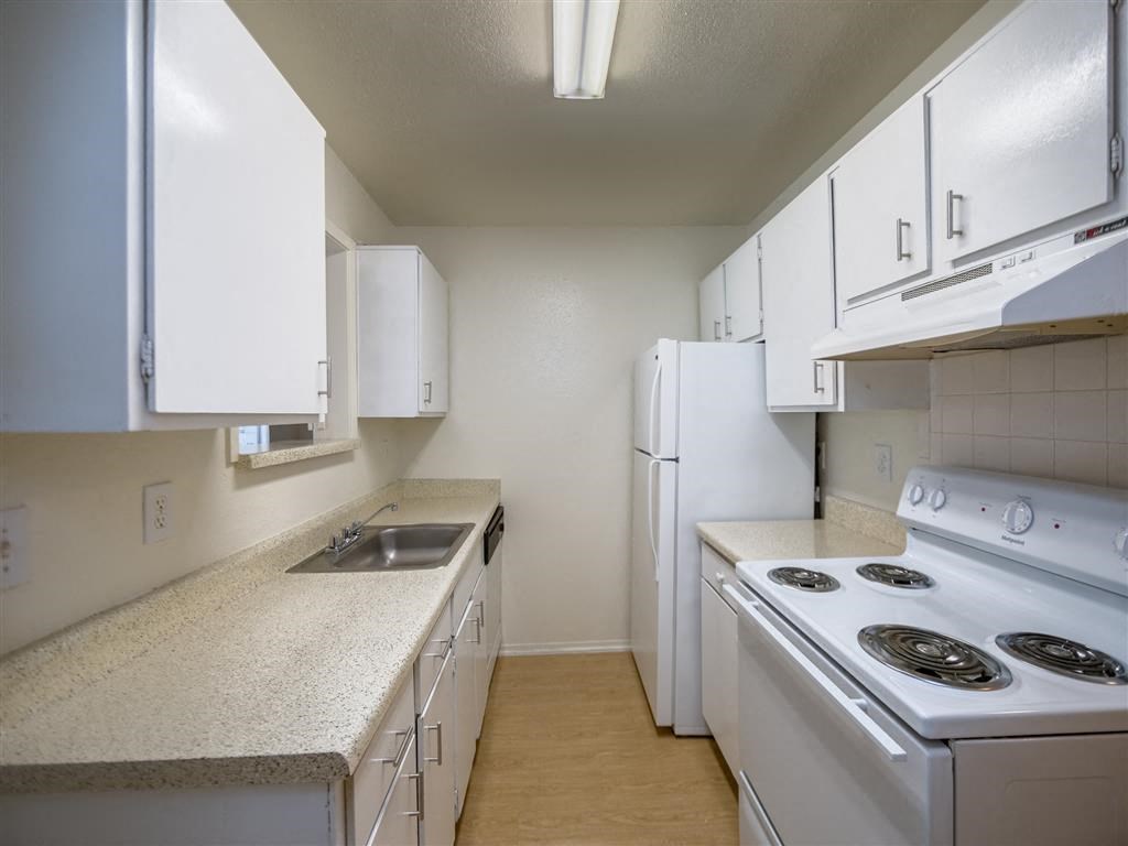 a kitchen with white appliances and white cabinets