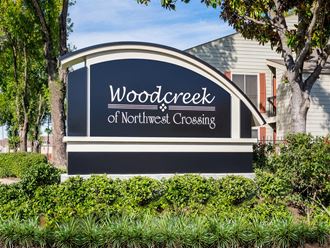 a sign that reads woodcrest of northwest crossing