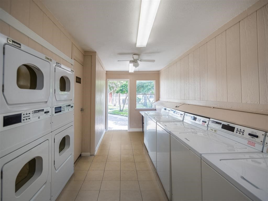 a laundry room with washes and dryers in it