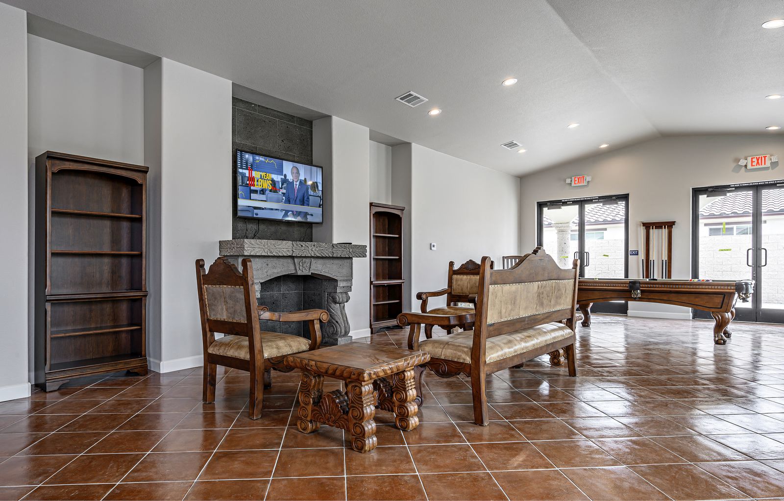a living room with a fireplace and a table with chairs