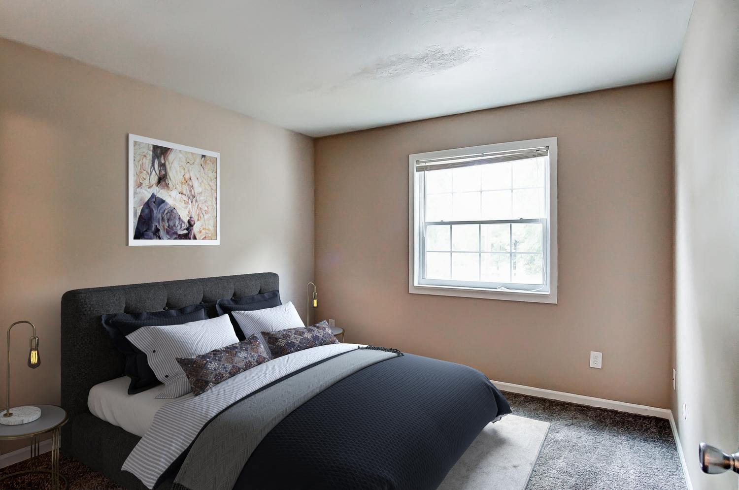 a bedroom with a bed and a window