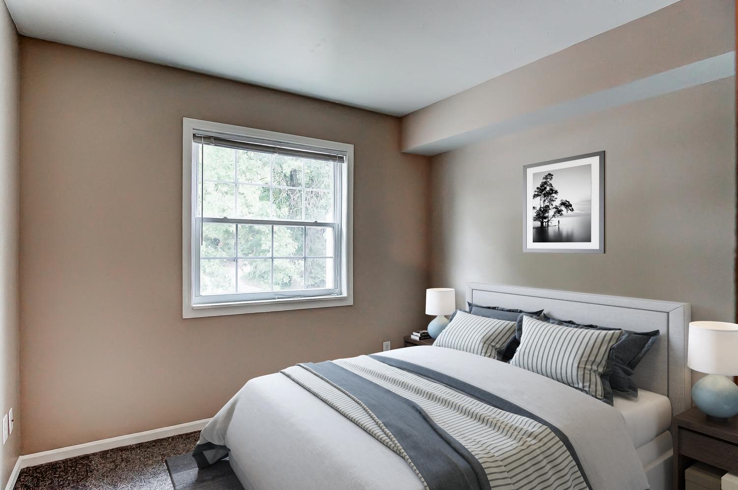 a bedroom with a bed and a window