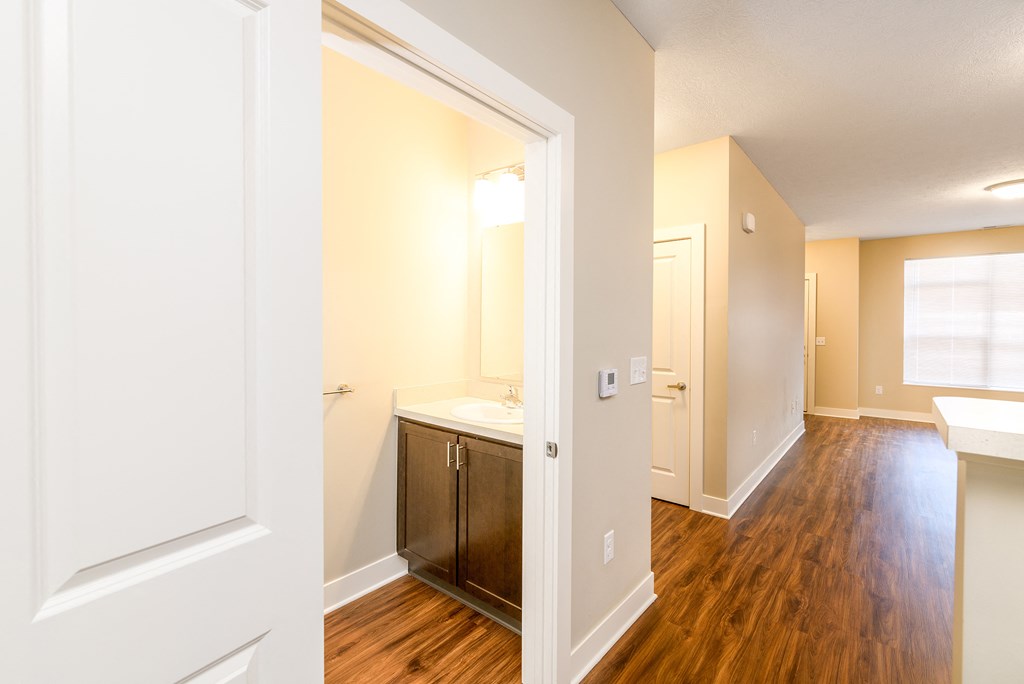a renovated bathroom with a sink and a mirror in an open door