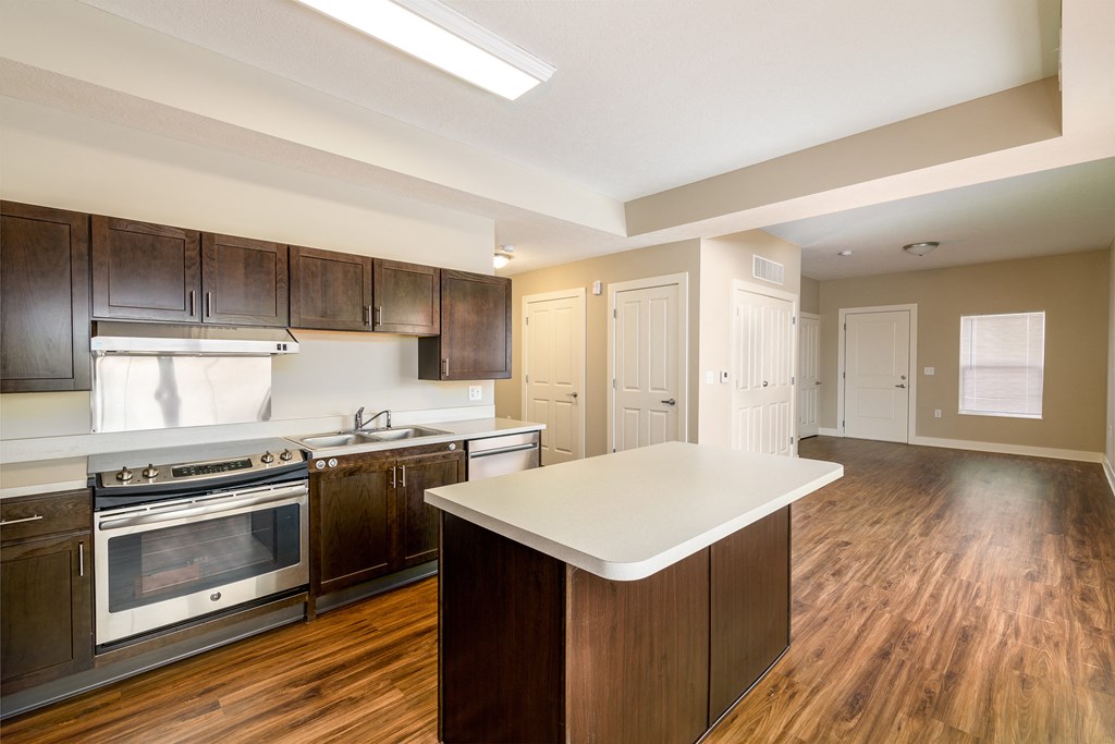 a kitchen with wooden cabinets and a white counter top in a new home