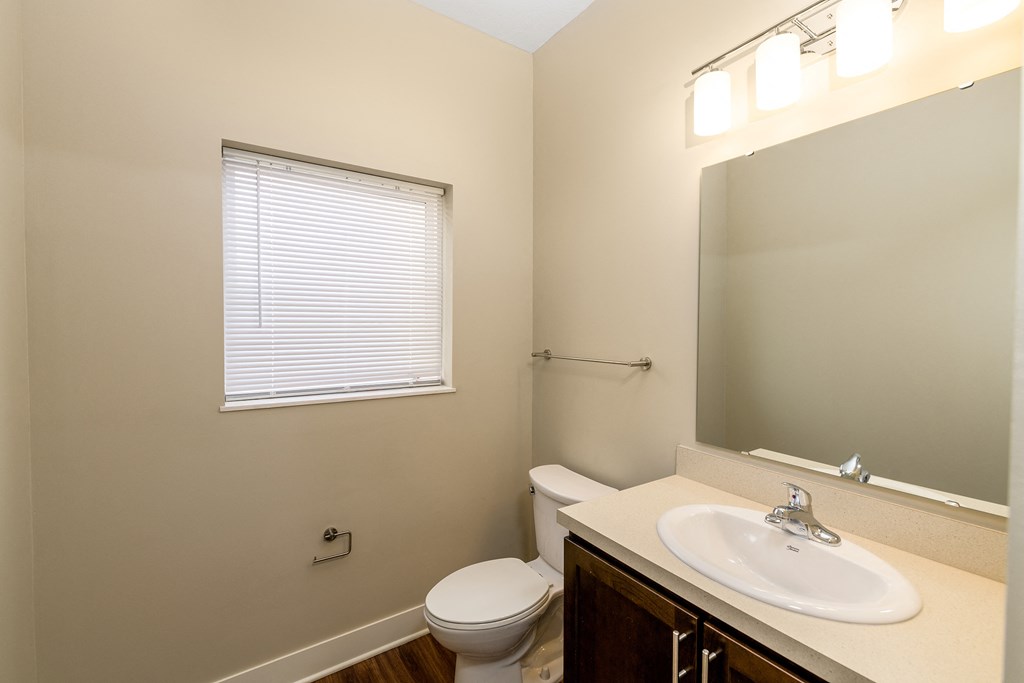 a bathroom with a sink toilet and a mirror