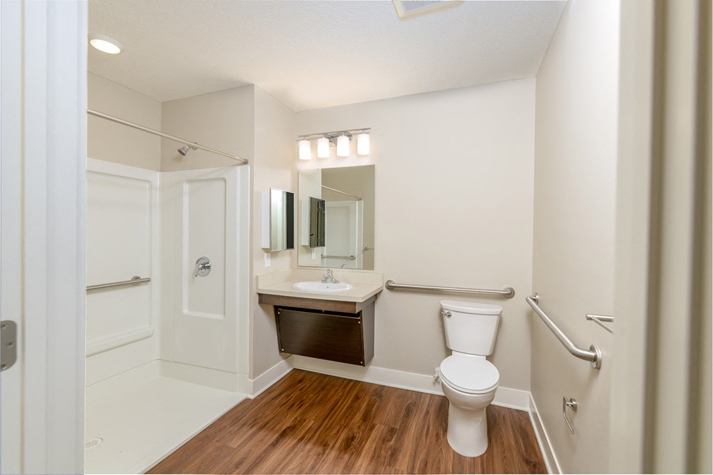 a bathroom with a toilet and a sink and a shower