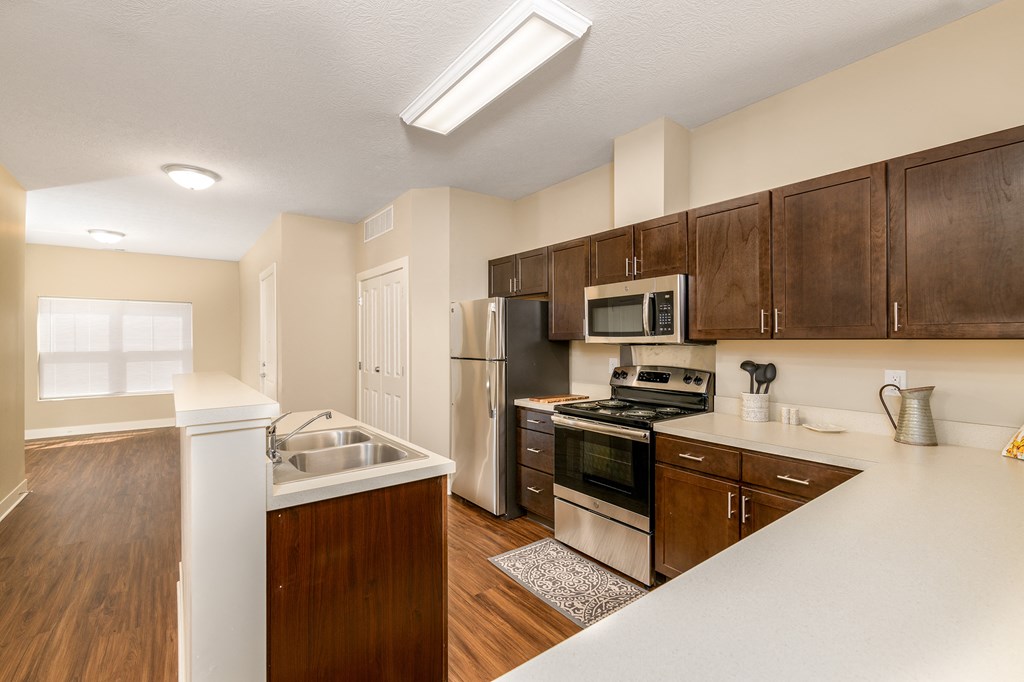 a kitchen with wooden cabinets and stainless steel appliances