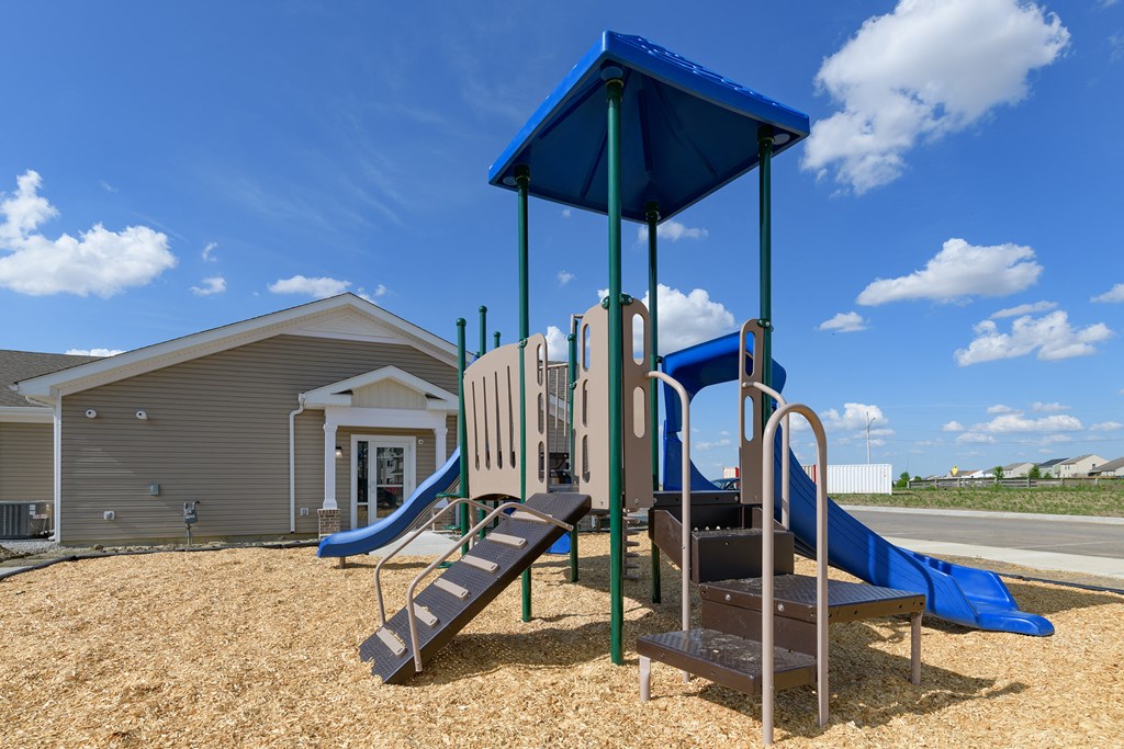 the preserve at ballantyne commons playground with play equipment and a building