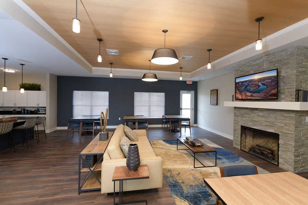 a living room with a fireplace and a table and chairs