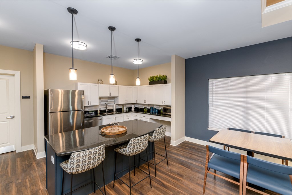 a kitchen with stainless steel appliances and a table with chairs