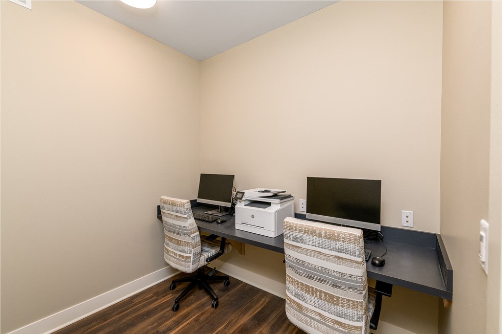 a home office with two desks and two computers