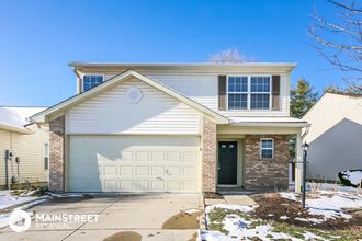 a white and brick house with a white garage door