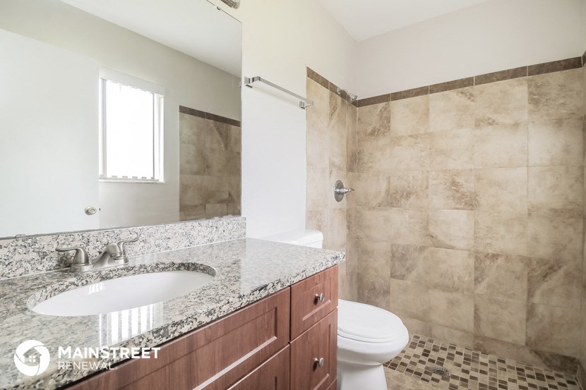 a bathroom with a sink and a toilet and a shower