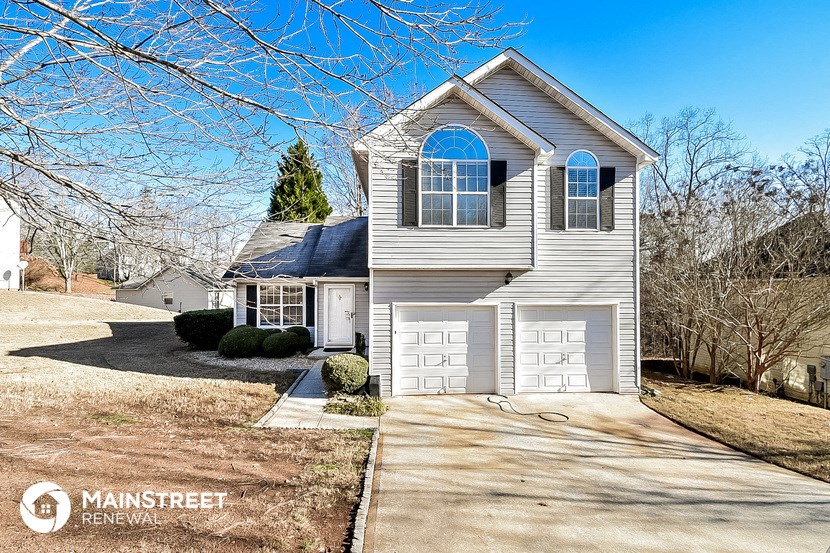 a white house with a white garage door and a white