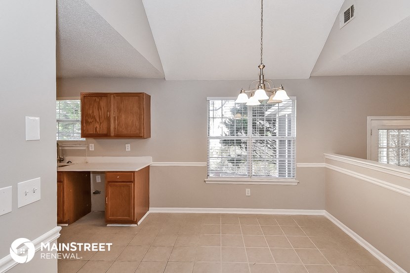 the kitchen is open to the dining room and living room