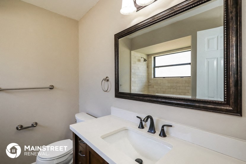 a bathroom with a sink and a mirror and a toilet
