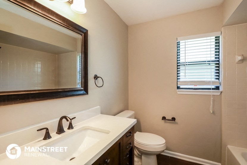 a bathroom with a sink and a toilet and a mirror