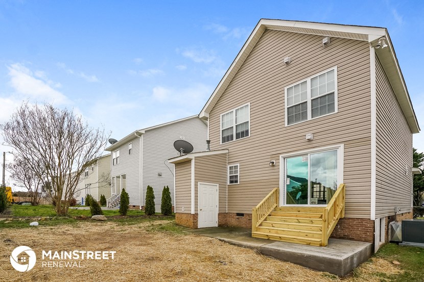 the exterior of a house with a wooden porch and stairs