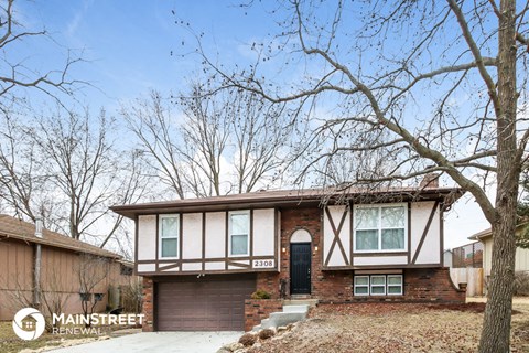 the front of a brick house with a black door