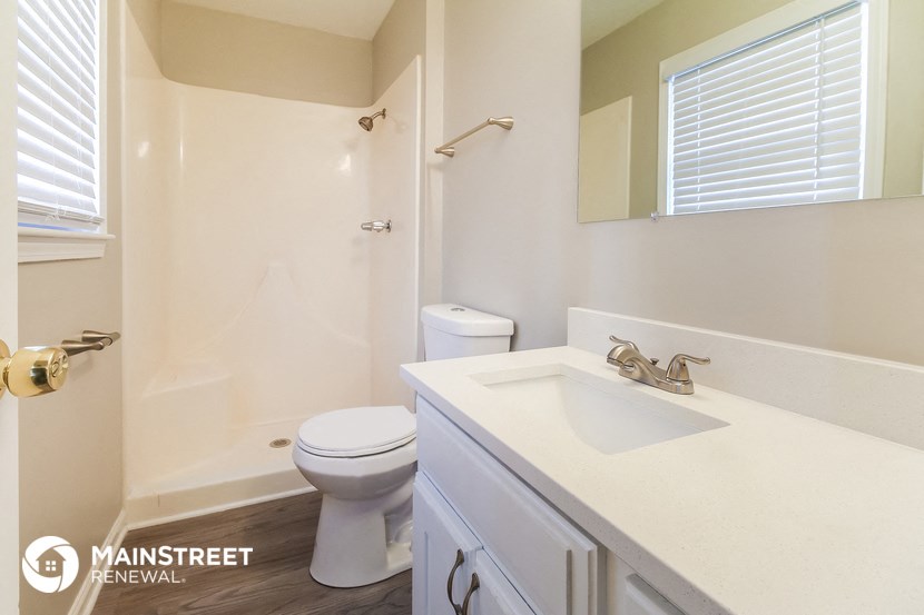 a bathroom with a sink and a toilet and a shower