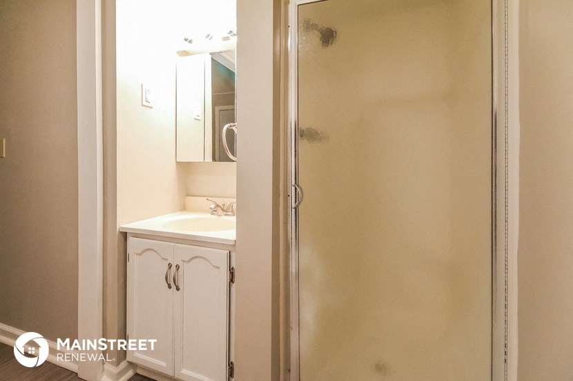 a small bathroom with a shower and a sink