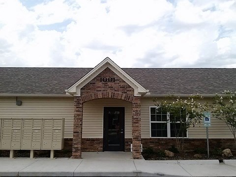 the front of a brick building with a black door