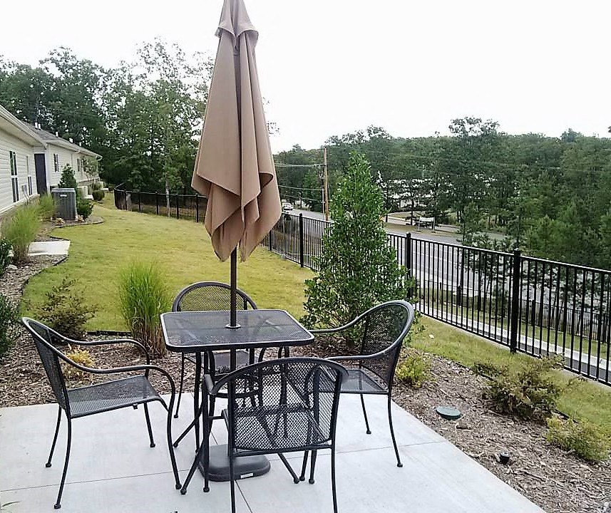 a patio with a table and chairs and an umbrella